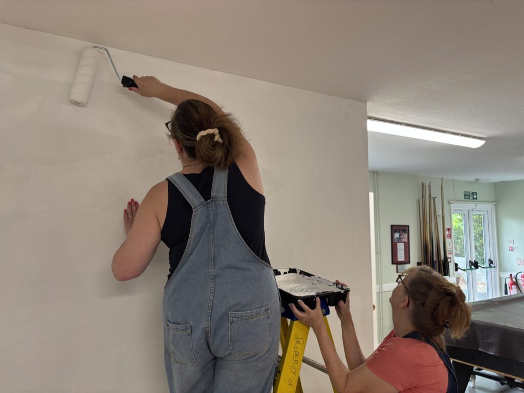 Rebecca and Philippa painting gallery wall white