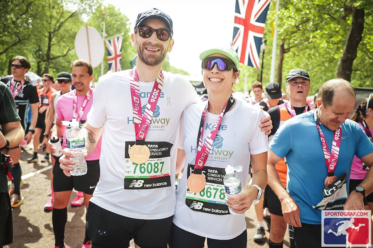 Two London Marathon finishers wearing Headway Thames Valley charity T-shirts