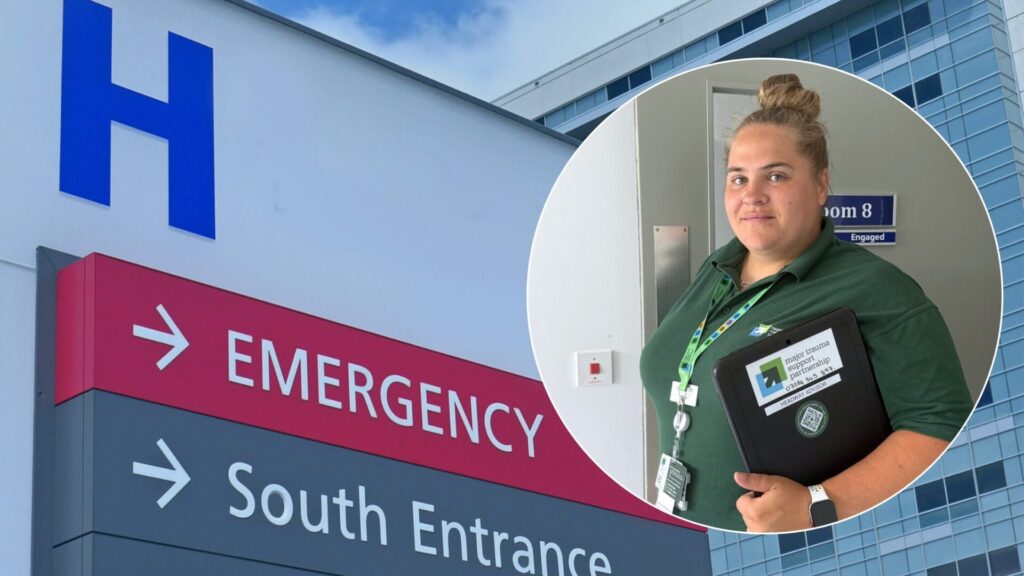 Headway Thames Valley Hospital Liaison Adviser in front of an hospital with a red emergency sign