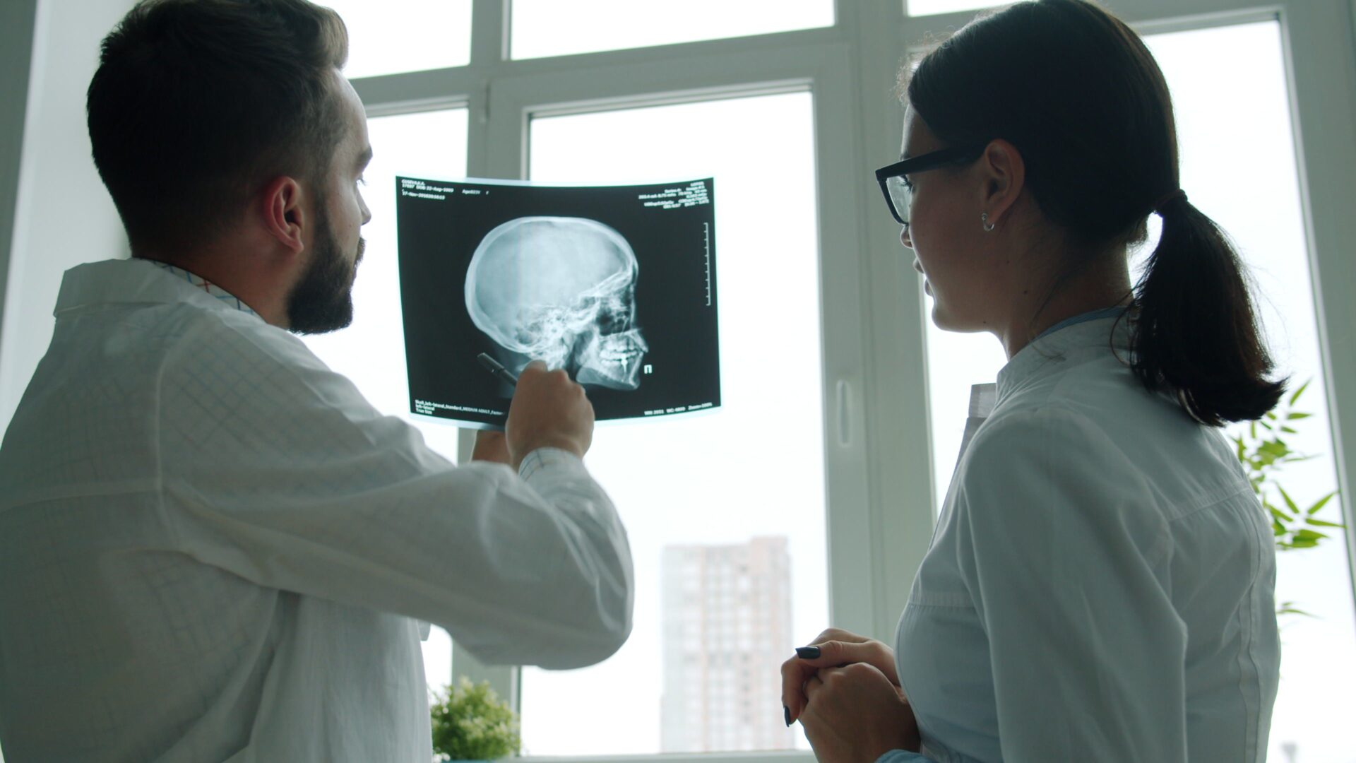 acquired brain injury claim professionals reviewing a skull X-ray in a medical office