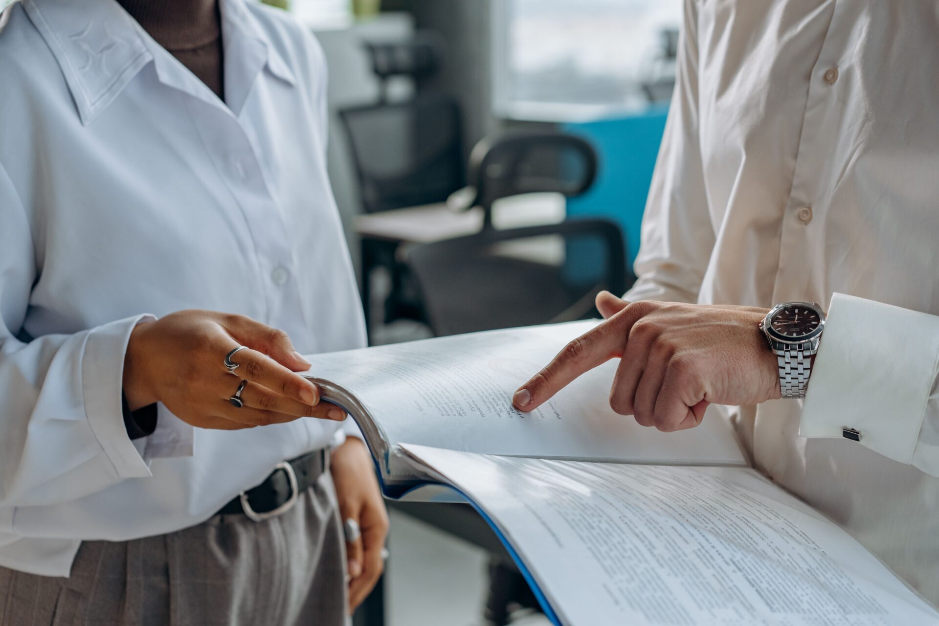 close up of collaborative document review by two professionals in an office setting